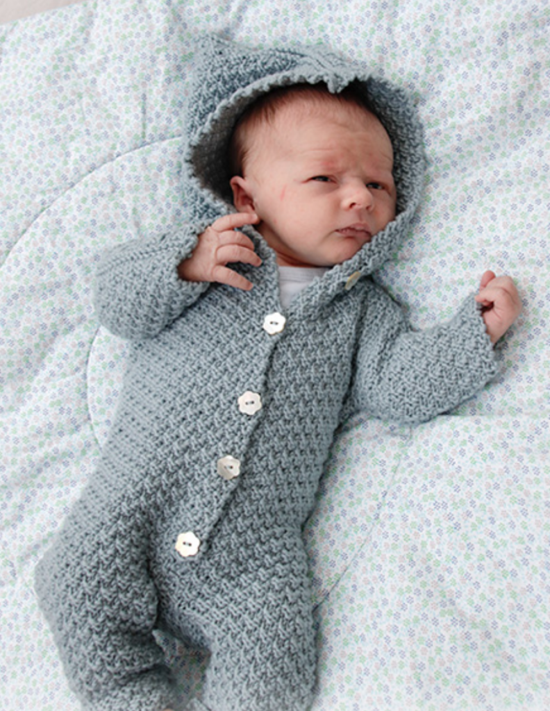 baby wearing a knitted onesie for the winter